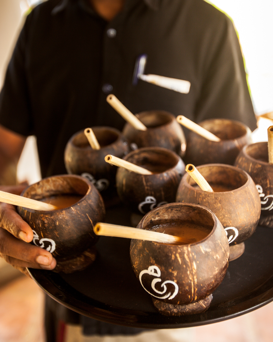 Closeup of hotel staff with coconut drinks