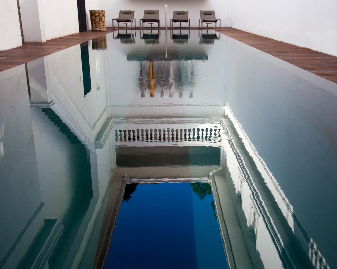Blue waters of reflective swimming pool in luxury hotel