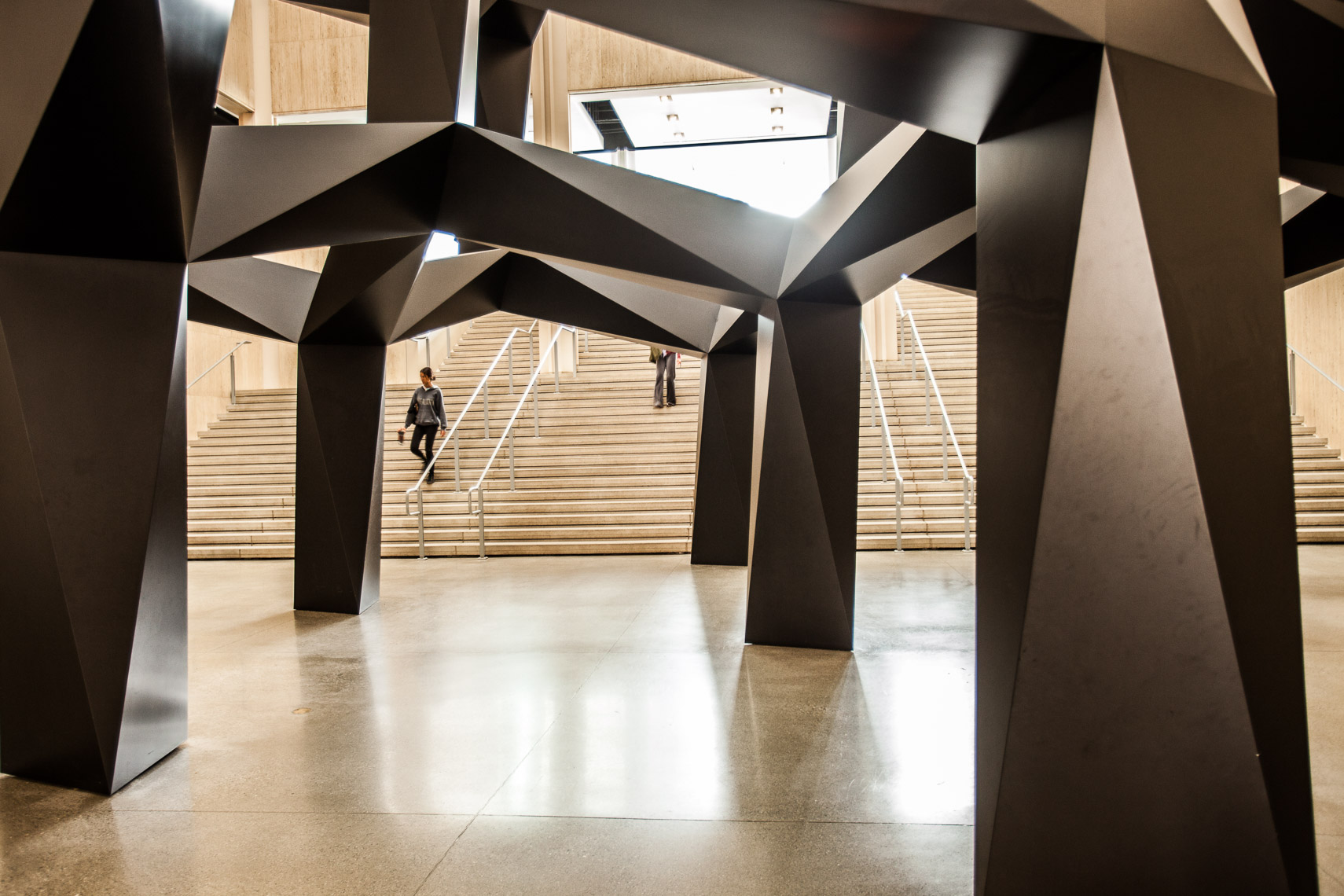 Interior hallway staircase with large sculpture installation lattice