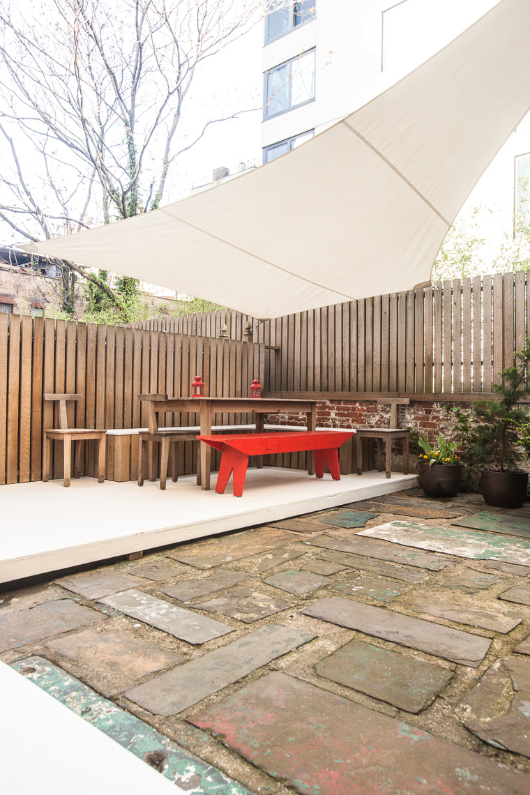 Backyard patio with angular sun shade