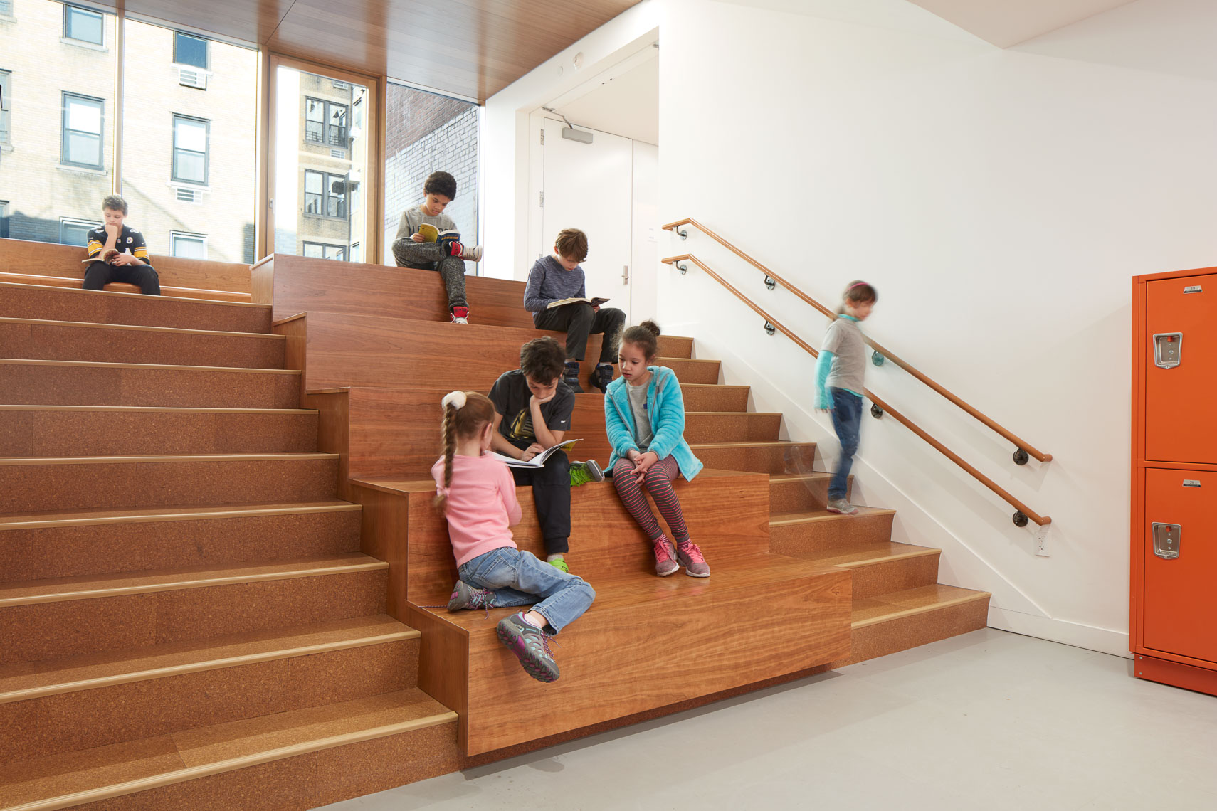 Students sit and work together on a staircase gallery