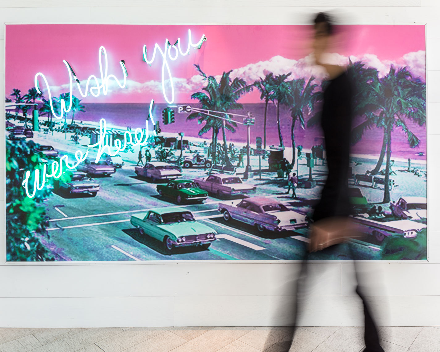 Blurry motion of person walking in front of colorful urban pop art