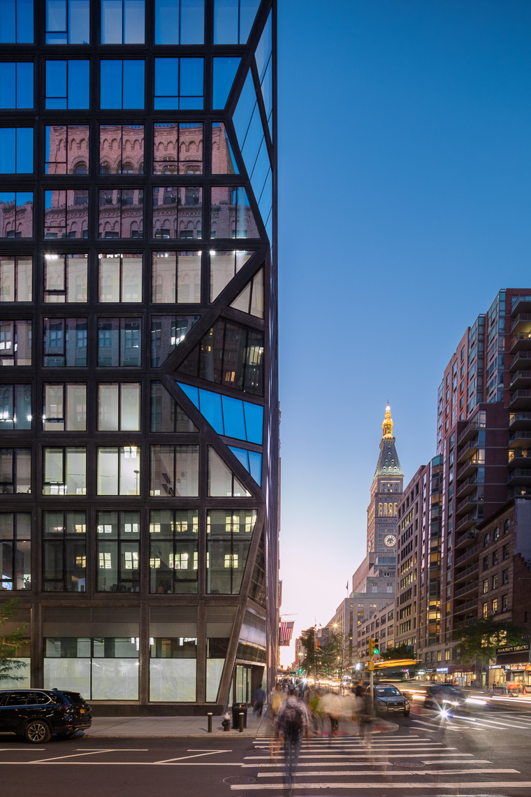 Dynamic glass residential tower and Manhattan streets at dusk