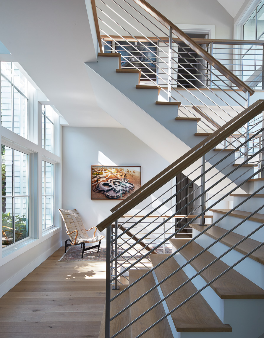 Dynamic staircase in a sunlit two story modern home