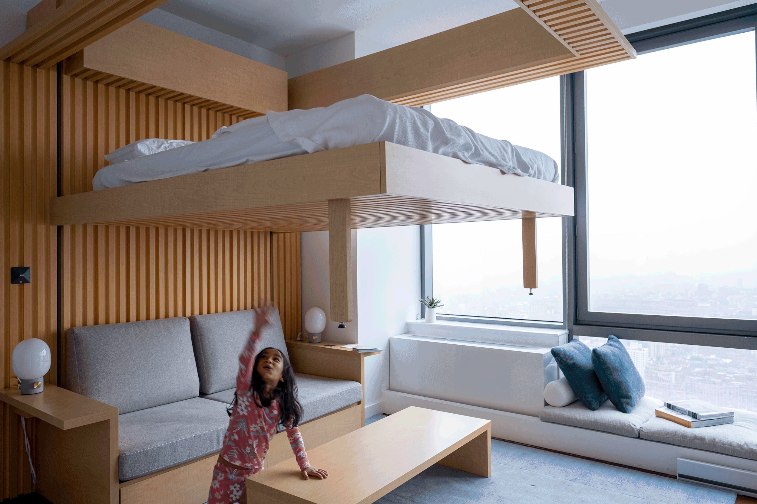 Animation of child and robotic furniture bed in a New York City apartment 