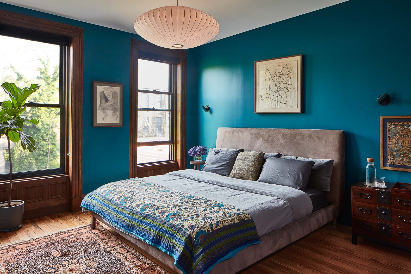 Master bedroom with turquoise walls and modern decor
