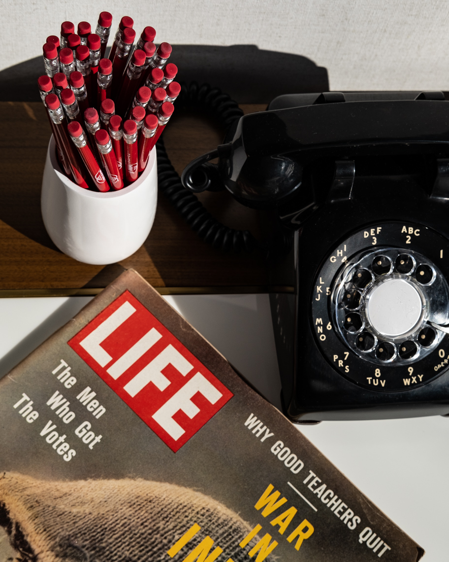 Detail of retro phone and notepad with TWA signature red pencils